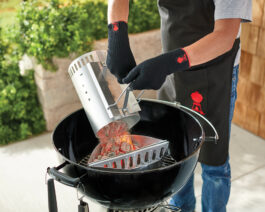 RapidFire Chimney Starter pouring lit coals into a grill.