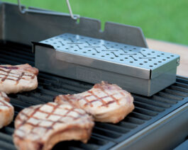 Smoker Box on grill with pork chops.