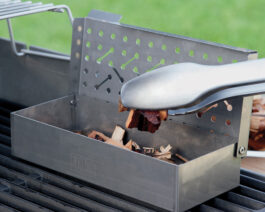 Smoker Box being filled with wood chips.