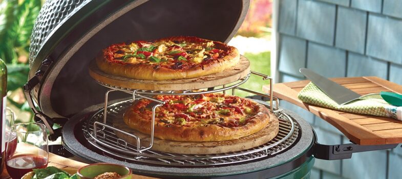 Pizza cooking on a Big Green Egg cooking rack extender set.