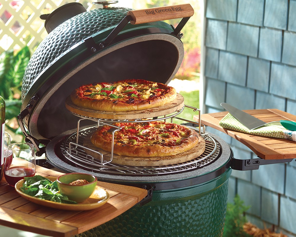 Pizza cooking on a Big Green Egg cooking rack extender set.