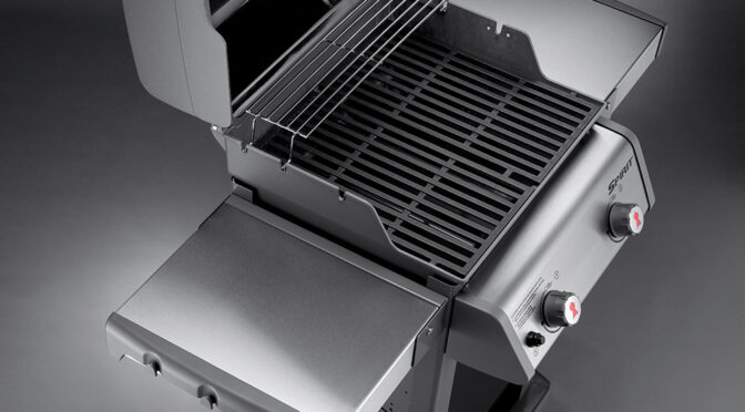 Spirit E-210 Gas Grill open to show detail.