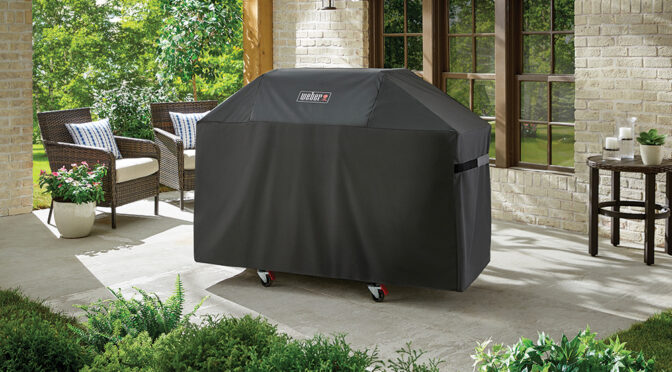 Genesis 300 Series Grill Cover on a grill on a patio.