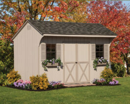 Standard 8x12 Wooden Quaker Shed in Sandstone Siding, Clay Trim, Almond Shutters and Brownstone Shingles. With Fall Foliage behind.