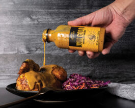 Liquid Gold BBQ Sauce being poured on chicken.