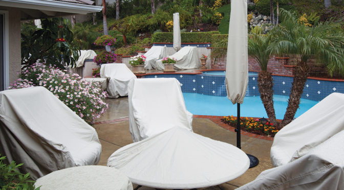 Patio furniture covered up by a pool.