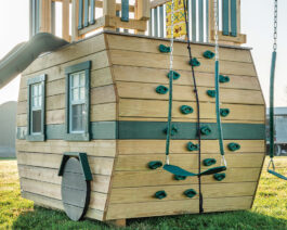 Wooden Scout camper playset, rock wall detail.