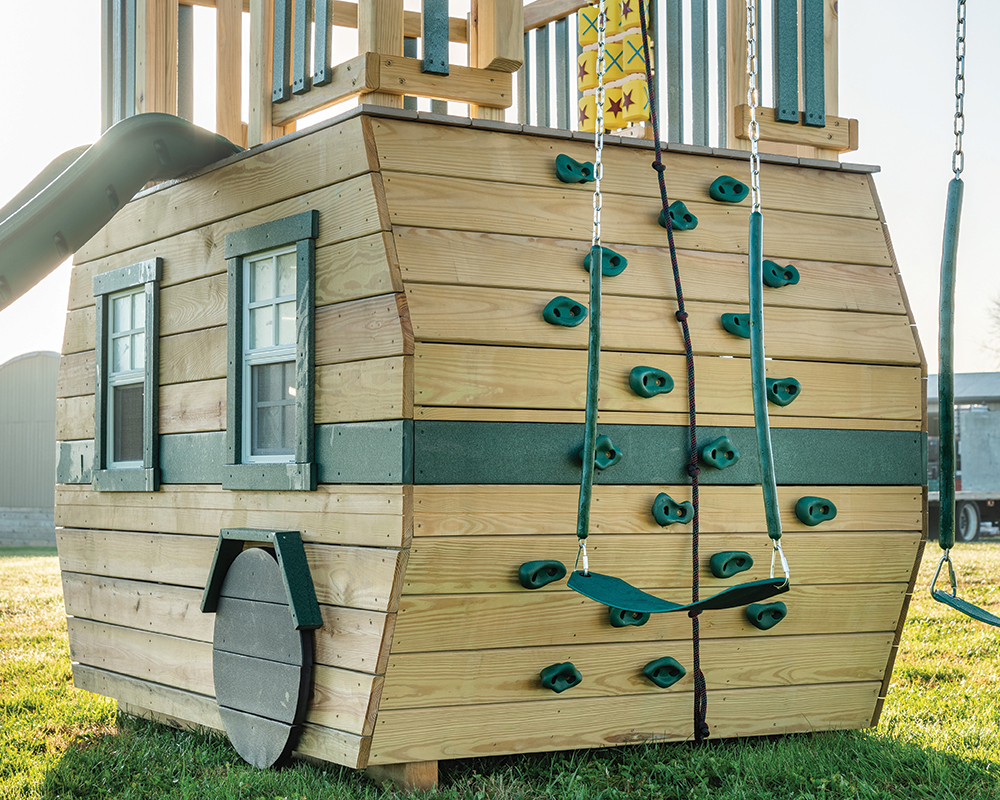 Wooden Scout camper playset, rock wall detail.
