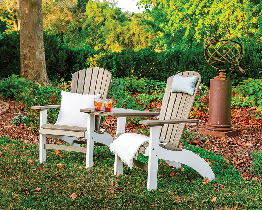 Deluxe Fanback Settee in barnwood on white with accent pillows in backyard.