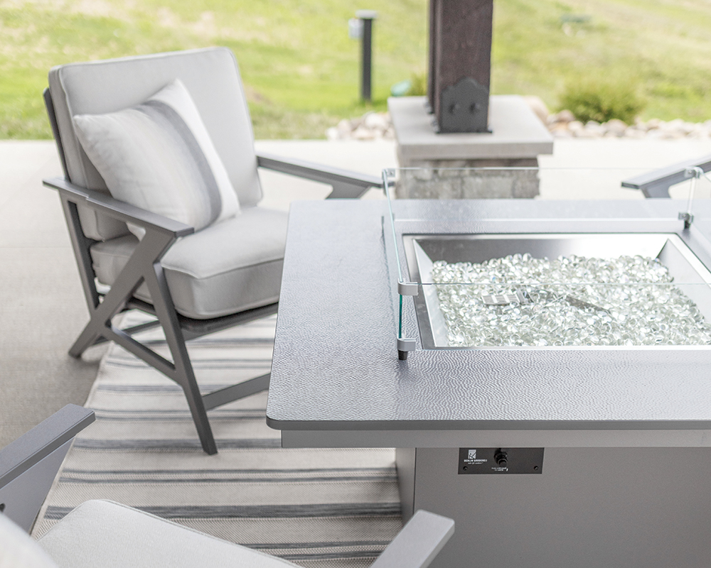 Graphite Numa Fire Pit with a Stainless Hammered Top.