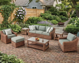 Miramar wicker sofa, chairs, ottoman, coffee table, and two end tables on a cozy brick backyard patio.